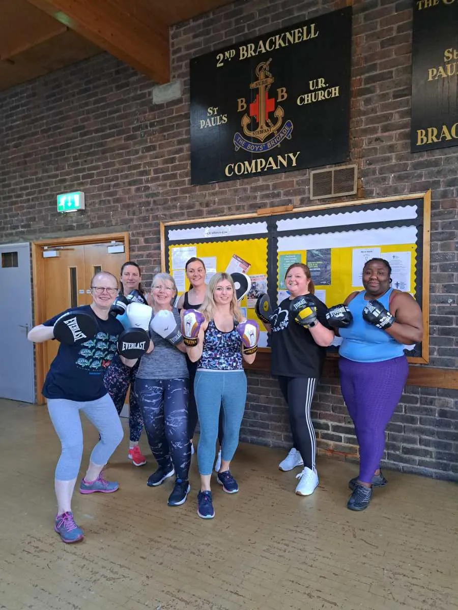 Group fitness class holding boxing pads at St Paul's Church Hall, Willing Spirit Exercise Bracknell