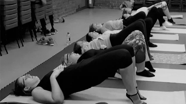 Mat based class working on core strength in a community hall near Bracknell, Willing Spirit Exercise